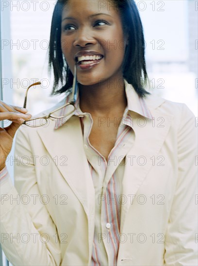 Woman biting eyeglasses