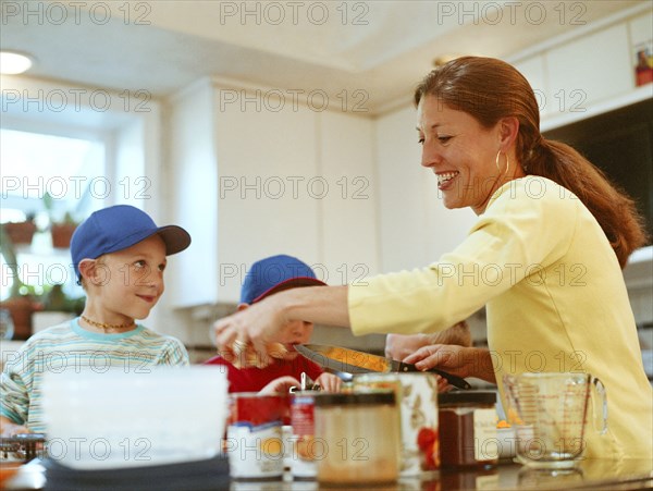 Caucasian mother and sons preparing food