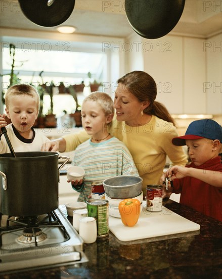 Caucasian mother and sons preparing food