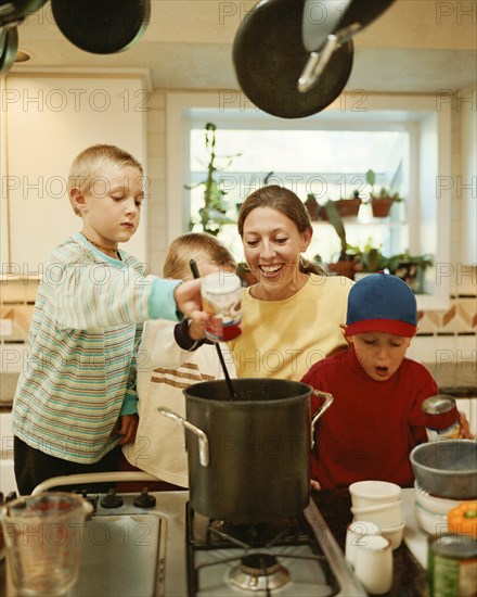 Caucasian mother and sons preparing food