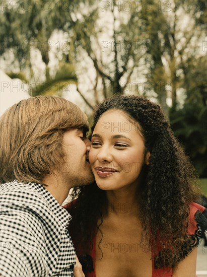 Couple kissing outdoors