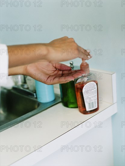 Woman using hand sanitizer