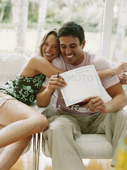 Couple hugging and holding certificate