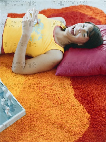 Woman laying on pillow on floor