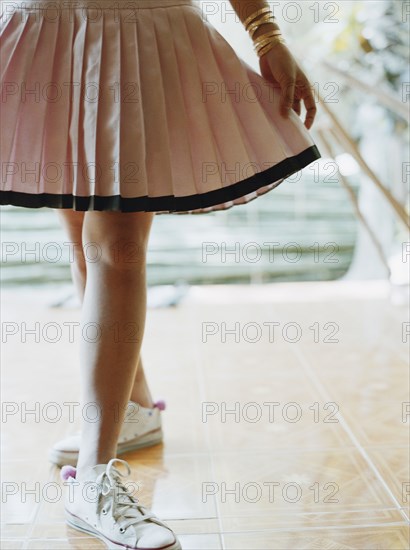 Woman in skirt and sneakers