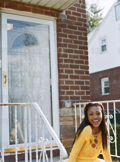 Woman sitting on front stoop