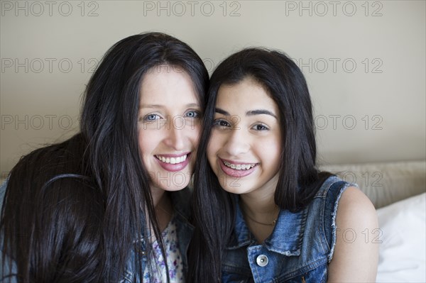 Hispanic mother and daughter smiling