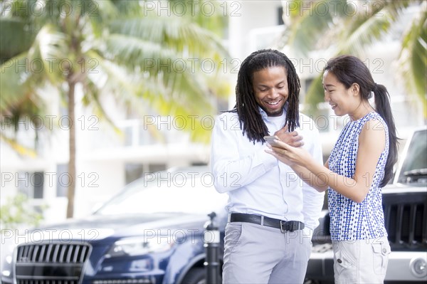 Business people using cell phone outdoors