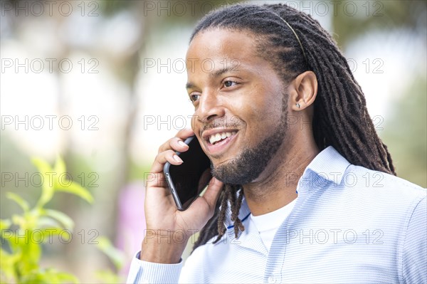 African American businessman talking on cell phone outdoors