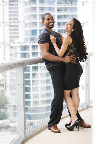 Couple hugging on urban balcony