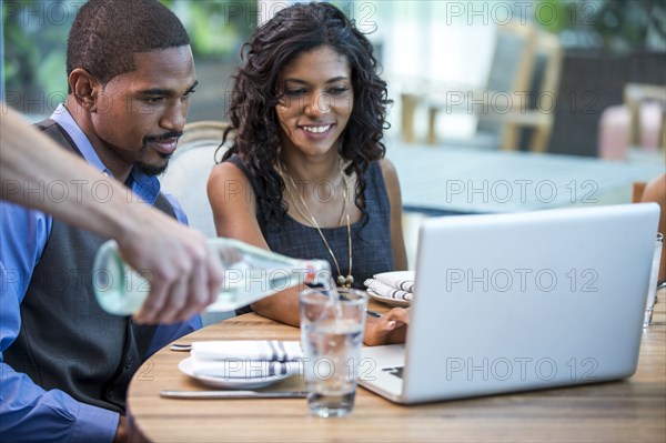 Business people working at lunch in cafe