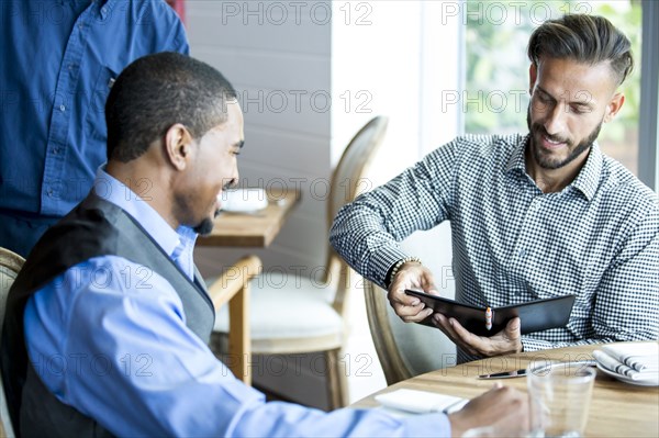 Businessman paying for lunch in cafe
