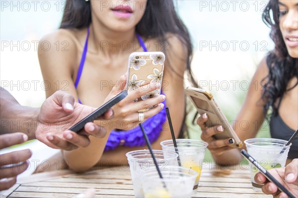 Women using cell phones at lunch