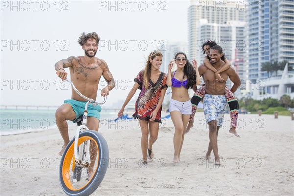 Friends walking on urban beach