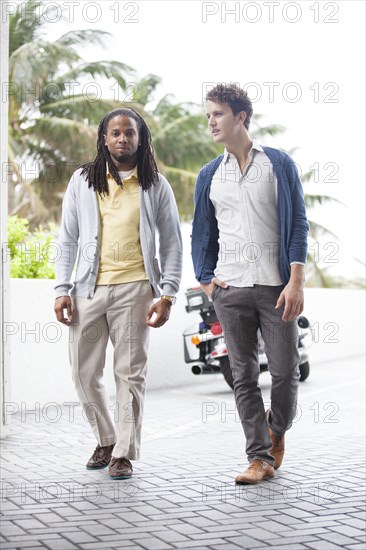 Businessmen walking on brick path