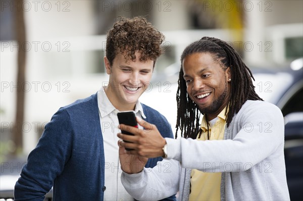 Businessmen using cell phone outdoors