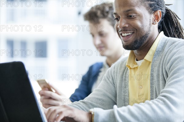 Businessmen using technology in office
