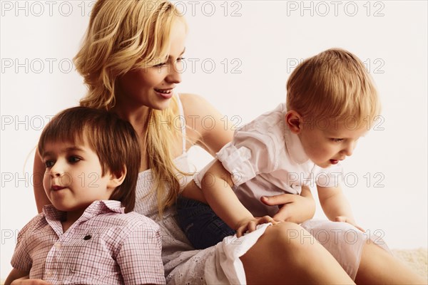 Smiling mother holding sons
