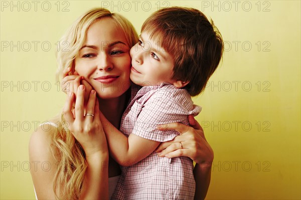 Smiling mother hugging son