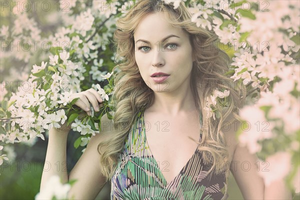 Caucasian woman standing in flowering tree