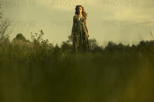 Caucasian woman walking in rural field