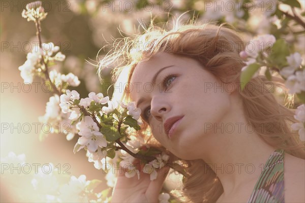 Caucasian woman standing in flowering tree