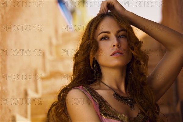 Caucasian woman leaning on staircase wall