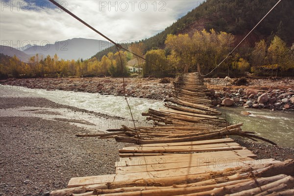 Wooden bridge over remote river