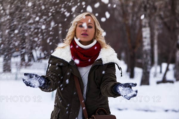 Caucasian woman playing in snow