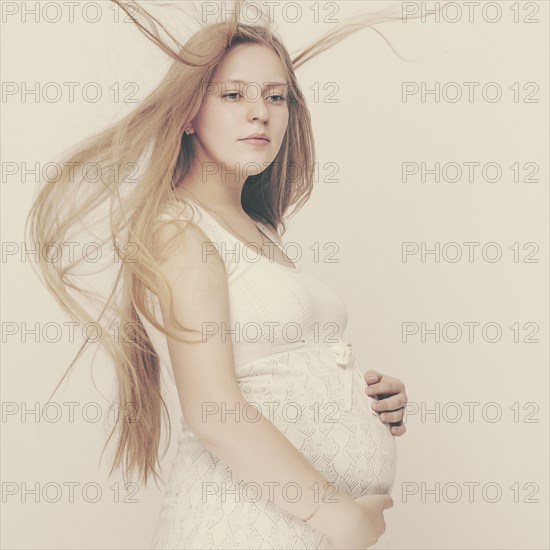 Pregnant woman with windblown hair