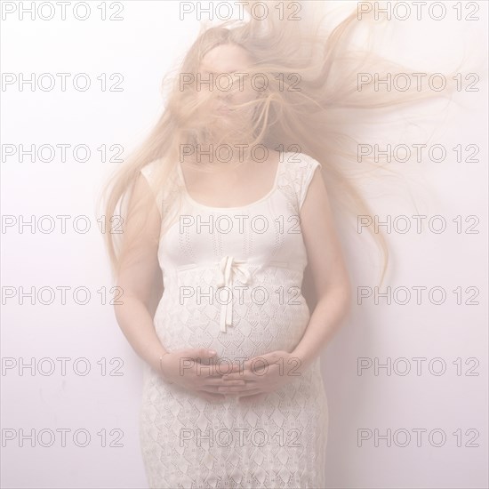 Pregnant woman with windblown hair