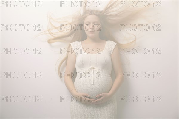 Pregnant woman with windblown hair