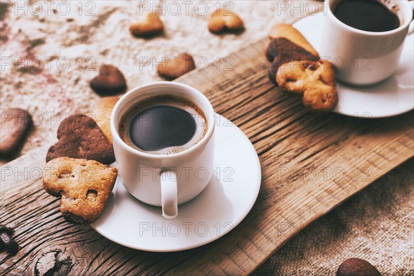 Coffee and heart-shape cookies on wooden tray