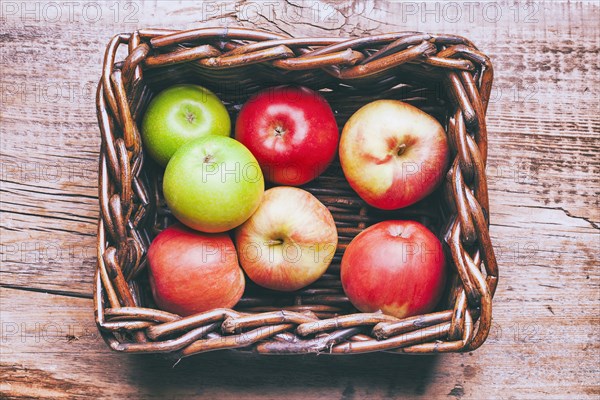 Basket of apples on wooden table
