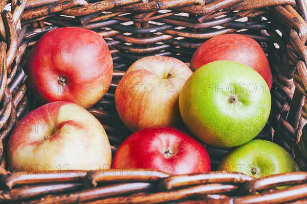 Basket of apples on wooden table