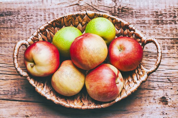 Basket of apples on wooden table