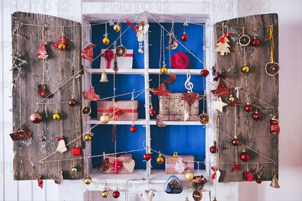 Gift boxes on wooden shelves near ornaments