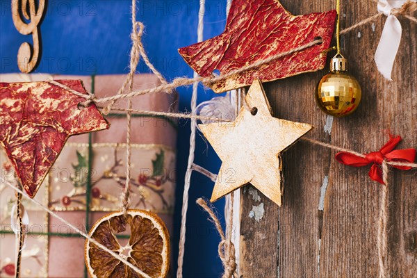 Ornaments hanging on string near gift box