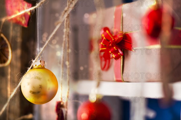 Ornaments hanging on string near gift box