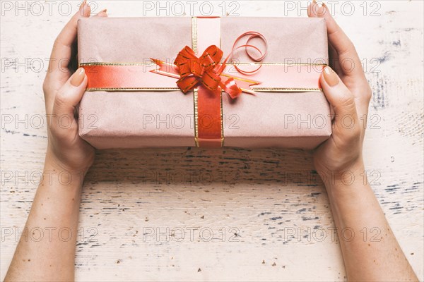 Hands of woman holding gift box