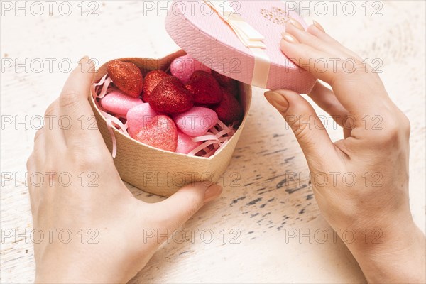 Hands of woman opening valentine gift box