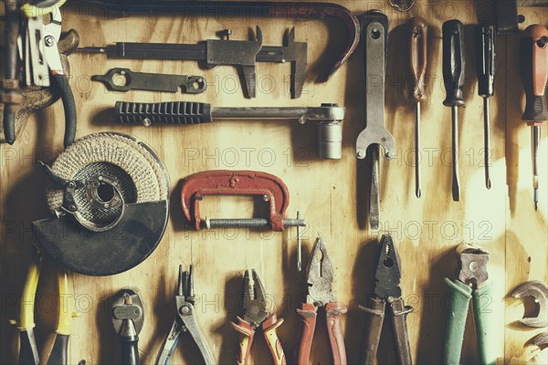 Tools hanging on wooden wall