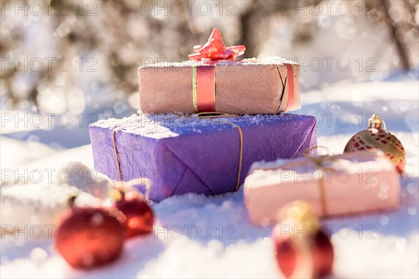 Christmas gifts and ornaments in snow