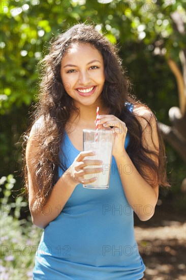 Mixed race woman drinking lemonade outdoors