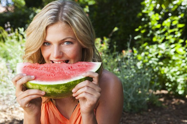 Caucasian girl eating watermelon