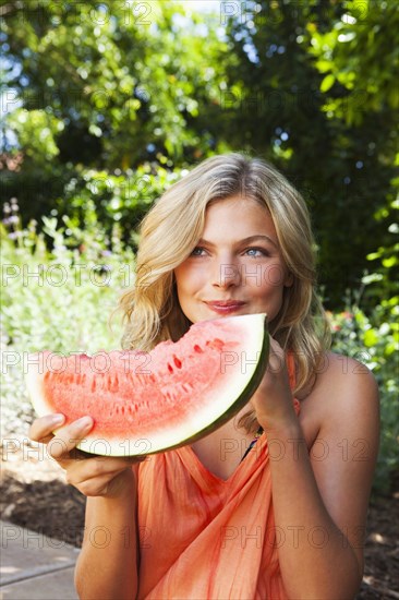 Caucasian girl eating watermelon