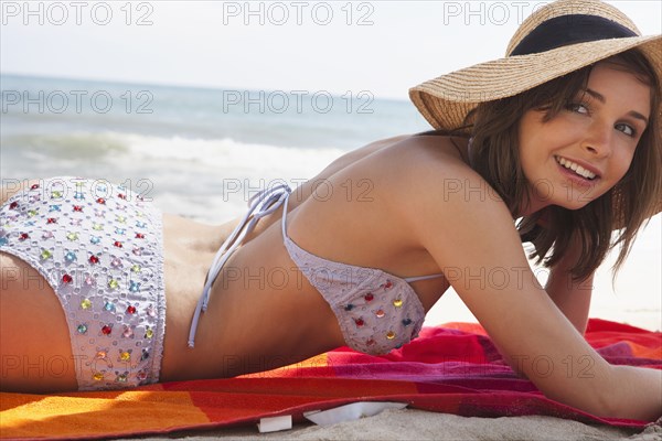 Caucasian woman laying on beach