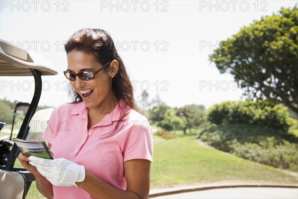 Woman keeping score during golf game