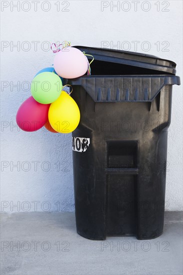 Bunch of balloons in garbage can