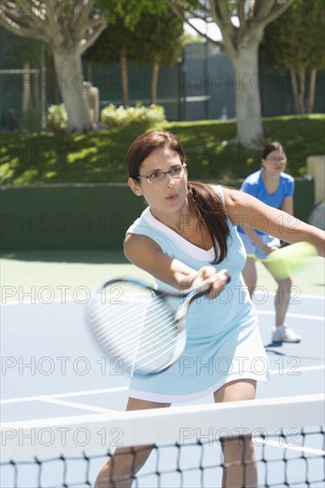 Woman playing tennis on court